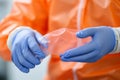 Close up scientist male female hands medical gloves in protective uniform nanotechnology fiber microbiology material