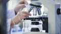 A close-up of a scientist\'s hands adjusting slides under