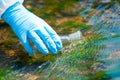 Close up of a scientist`s river drawing water into a research flask