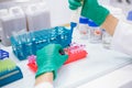 scientist using pipette transfer sample to Micro Centrifuge Tube for PCR test in Biosafety cabinet