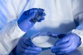 Close up of scientists hands with chemicals in lab