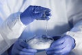 Close up of scientists hands with chemicals in lab