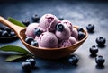 A close-up of a scoop of blueberry ice cream with fresh blueberries on top.