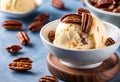 A close-up of a scoop of butter pecan ice cream with pecans on top.