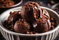A close-up of a scoop of chocolate fudge brownie ice cream with chunks of brownie on top.