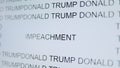 Close up of a screen showing the word impeachment surrounded by the words Donald Trump. The concept of impeachment