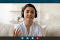 Indian woman in earphones talk on video call Royalty Free Stock Photo