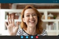 Smiling woman wave to camera talking on video call Royalty Free Stock Photo