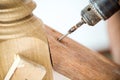 Close up screwdriver auto machine is screwing the nut in to the wood. image for background Royalty Free Stock Photo