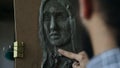 Close-up of Sculptor creating sculpture of human`s face on canvas in art studio Royalty Free Stock Photo