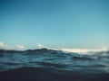 Close up of sea wave. Front view on beautiful sea wave on sandy beach. Summer sunny day, blue sky, water background. Blur effect Royalty Free Stock Photo