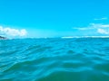 Close up of sea wave. Front view on beautiful sea wave on sandy beach. Summer sunny day, blue sky, water background Royalty Free Stock Photo