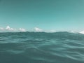 Close up of sea wave. Front view on beautiful sea wave on sandy beach. Summer sunny day, blue sky, water background Royalty Free Stock Photo