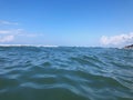 Close up of sea wave. Front view on beautiful sea wave on sandy beach. Summer sunny day, blue sky, water background Royalty Free Stock Photo