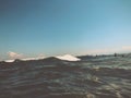 Close up of sea wave with splashes. Front view on beautiful sea wave on sandy beach. Summer sunny day, blue sky, water background Royalty Free Stock Photo