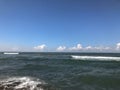 Close up of sea wave with splashes. Front view on beautiful sea wave on sandy beach. Summer sunny day, water background Royalty Free Stock Photo