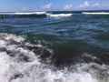 Close up of sea wave with splashes. Front view on beautiful sea wave on sandy beach. Summer sunny day, water background Royalty Free Stock Photo