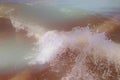 Close up of sea wave with splashes. Front view on beautiful sea wave on sandy beach. Summer sunny day, water background Royalty Free Stock Photo