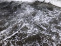 Close up of sea wave with splashes. Front view on beautiful sea wave on sandy beach. Summer sunny day, water background Royalty Free Stock Photo