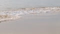 Close-up of sea waves on the sandy coast