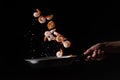Close-up, Seafood, chef cooks shrimp fry in a frying pan. On a black background for design, menus, restaurants, oriental cuisine,