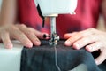 Close-up seamstress hands working on sewing machine at home. Sewing process. woman hands behind sewing close-up Royalty Free Stock Photo