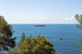 Close-up of the seascape. Blue sea, clouds over the horizon and cargo ships