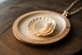 Close-up of a seashell necklace on a wooden table