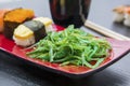 Seaweed salad and sushi served on the plate