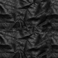 Close up of a section of a black leather swatch showing grain and a shaft of light across Royalty Free Stock Photo