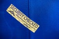 Close up security checked label on blue suitcase