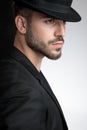 Close up of seductive young man wearing black hat