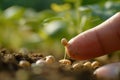 A close-up of a seed on a fingertip against a blurred green background, symbolizing growth and nature