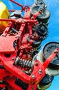 Close-up of seeder. Parts and mechanisms of agricultural machinery on background of blue sky
