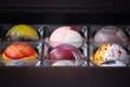 Close up of selection of colorful sweet delicious round shape chocolates in a box