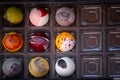 Close up of selection of colorful sweet delicious round shape chocolates in a box