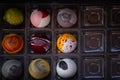 Close up of selection of colorful sweet delicious round shape chocolates in a box