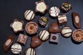 Close up of a selection of luxury chocolates, with a variety of shapes including a heart, florentines, and pistachios. Royalty Free Stock Photo