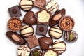 Close up of a selection of luxury chocolates, with a variety of shapes including a heart, florentines, and pistachios. Royalty Free Stock Photo