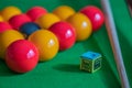 Pool balls, chalk and cue on a pool table Royalty Free Stock Photo