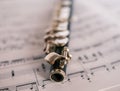 Close up of wooden flute on unidentifiable sheet music Royalty Free Stock Photo