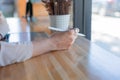 Close up and selective focus with copy space of business woman hand with stylus and using tablet to do her work on wooden counter