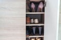Selective focus fashionable women high heels and leather men shoes keep in cabinet for going to work in office