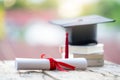 Close-up selective focus of a graduation cap or mortarboard and diploma degree certificate put on table Royalty Free Stock Photo