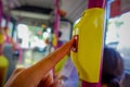 Close up of selective focus of a hand pushing a bus Stop Button inside of the bus, public transport in Singapore Royalty Free Stock Photo