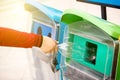 Close up Selective focus hand throwing empty plastic bottle into the trash.Woman hand putting empty plastic bottle in recycling bi