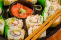 Close up of selective focus of large set of delicious japanese sushi rolls on a black plastic plate Royalty Free Stock Photo