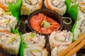 Close up of selective focus of large set of delicious japanese sushi rolls on a black plastic plate Royalty Free Stock Photo