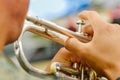 Close up of selective focus of man in national military parade playing the trumpet during the diablada festival