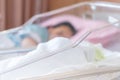 Close up and Selective focus of newborn baby boy and new mother sleeping in a hospital Royalty Free Stock Photo